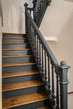 an image of a stair case with wood floors and handrails in the house