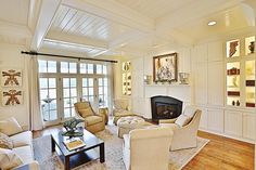 a living room filled with furniture and a fire place in the middle of a room