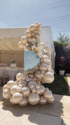 a table topped with lots of white balloons