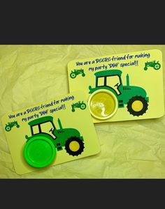 two magnets with tractors on them sitting next to each other