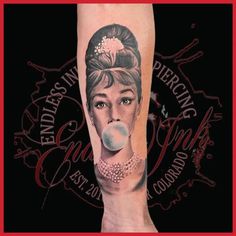 a woman with a bubble in her mouth is shown on the leg and has tattoos on it