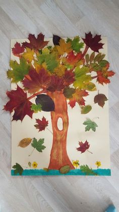 a child's drawing of a tree made out of leaves on a piece of paper