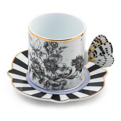 a cup and saucer with a butterfly on it