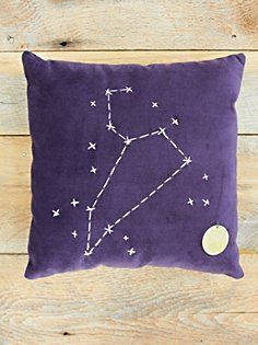 a purple pillow with the zodiac sign on it and a white star in the middle