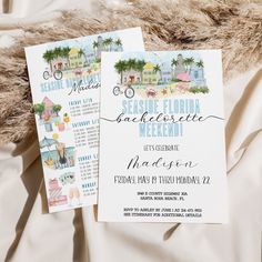 the wedding stationery is laid out on top of a bed with white sheets and fur