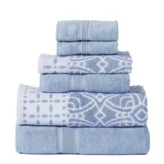 four towels stacked on top of each other in blue and white colors with an intricate design