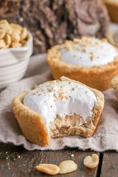 two desserts with white frosting and nuts in the background