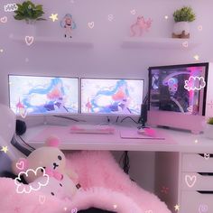 two computer monitors sitting on top of a desk next to a pink teddy bear pillow