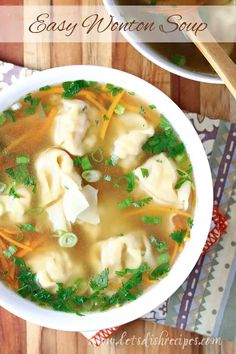 a bowl of soup with dumplings, carrots and parsley on the side