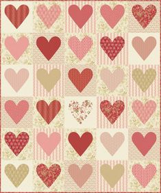 a quilt with many hearts on it, including one in red and the other in pink