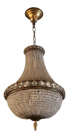 a chandelier hanging from the ceiling with lots of crystal beads on it's sides