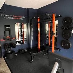 a gym room with various equipment and mirrors on the wall, including an exercise station