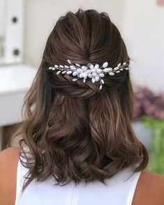 a woman wearing a hair comb with flowers on it