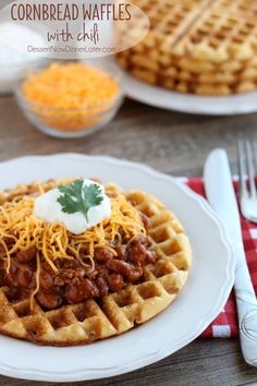 a white plate topped with waffles covered in chili and cheese