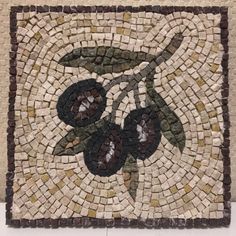 a mosaic tile with an olive on it's side and brown trim around the edges