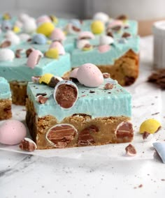 there are several pieces of cake with candy on the top and one slice has marshmallows