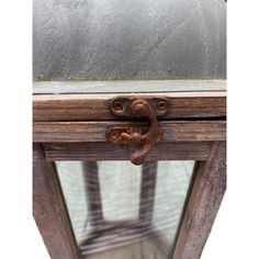 an old wooden table with a metal handle on it's top and bottom part