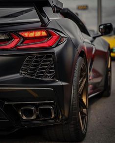 the rear end of a black sports car