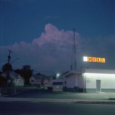 an empty gas station at night with the lights on