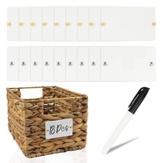 a basket with two white tags and a black pen next to it on a white background