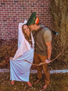 a man and woman dressed in costumes standing next to each other