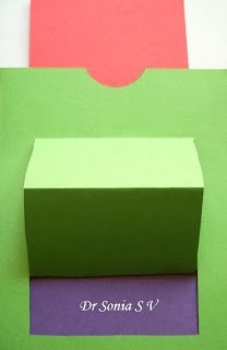 three different colored boxes sitting on top of each other