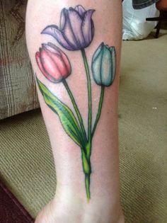 a woman's foot with flowers painted on the leg and one flower in the center