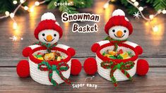 two snowman baskets with candy in them