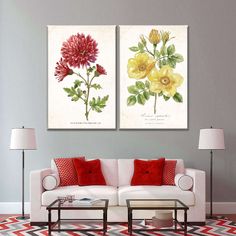 two paintings on the wall of a living room with red and yellow flowers in them