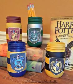 harry potter jars are stacked on top of each other next to books and pencils