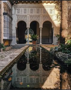 an old building with water in the courtyard