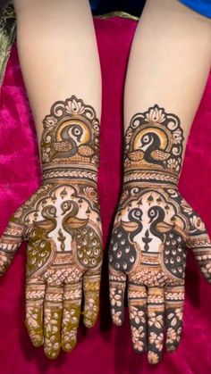 the hands and feet of a woman with henna tattoos on their arms, both decorated with