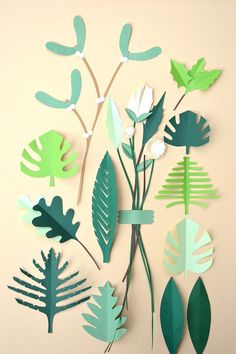 paper cut flowers and leaves on a beige background