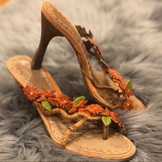 Beautiful Morenatom High Heel Sandals! Pre-Owned! Embellished With Burnt Orange Flowers Made Of Calf Hair Leather With Crystal Centers, As Well As Orange And Green Patent Leather Leaves On Vines Made Of Braided Suede And Embossed Tan Leather That Wrap Around The Top Of The Shoe. Also Note The Hand Stitching On The Insole. Leather Soles With Sculpted Reversed Stack Heels 4" Made In Brazil No Original Box/ Dust Bag But Will Ship In A Cute Gift Bag Burnt Orange Flowers, Leather Leaf, Orange And Green, Suede Sandals, Calf Hair, Cute Gift, Orange Flowers, Heel Sandals, Stacked Heel