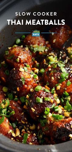 slow cooker thai meatballs in a crock pot with green onions and sesame seeds