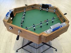 a foosball table with blue and silver accessories on it's legs in a room