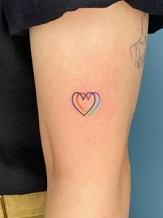 a woman with a heart tattoo on her left side ribcading the lower arm