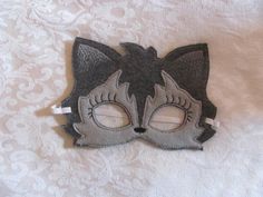 a cat mask is sitting on a bed