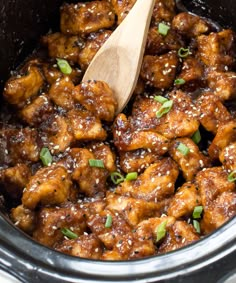 a slow cooker filled with chicken and sesame seeds