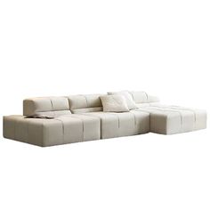 a white couch with pillows on top of it