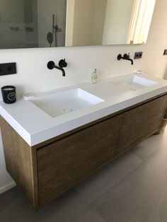 a bathroom with two sinks and a large mirror