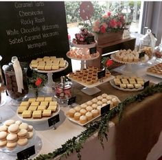 desserts and pastries are displayed on a table