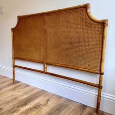 the headboard is made out of bamboo and has two wooden posts on each side