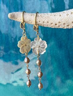 Beautiful carved mother of pearl flower on gold vermeil earrings with a labradorite tear drop gemstone and champagne fresh water pearls.  High quality gold vermeil earrings.  The earrings measure approximately 2 3/4" long.  Flower is approximately 1".  Freshwater pearl dangle measures 1.5". Simple and elegant chic look! Beautiful bridesmaid gift, perfect for a beach wedding! Ships ready for gifting in wrapped in a gauze bag. Yellow Gold Mother Of Pearl Jewelry With Pearl Drop, Handmade Yellow Gold Mother Of Pearl Jewelry, Elegant Mother Of Pearl Flower Shaped Jewelry, Dainty Pearl Jewelry With Gemstones, Unique Pearl Drop Jewelry, Elegant Pierced Jewelry In Mother Of Pearl, Unique Mother Of Pearl Drop Jewelry, Elegant Mother Of Pearl Jewelry, Yellow Gold Pearl Drop Earrings With Mother Of Pearl