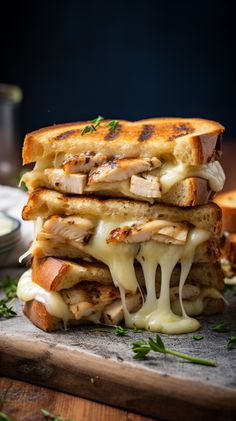 a grilled chicken and cheese sandwich is stacked on top of each other with melted cheese