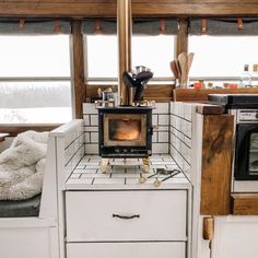 a stove top oven sitting inside of a kitchen next to an oven and countertop