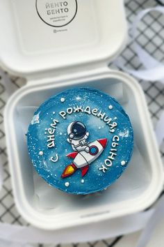 a blue cupcake with an astronaut on it