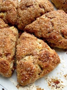 a bunch of food that is sitting on a white tablecloth with some powdered sugar