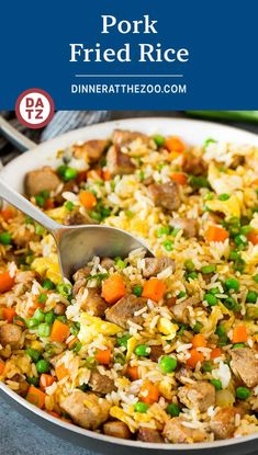 a skillet filled with fried rice and veggies on top of a table