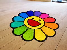 a colorful rug with a smiley face on the floor